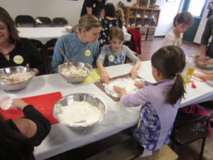 Family with mixing bowl and flour