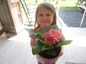 girl holding flower pot