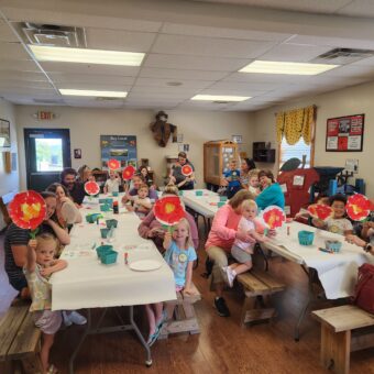 Families holding up crafts
