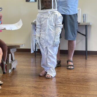 Young boy in bee keeper outfit