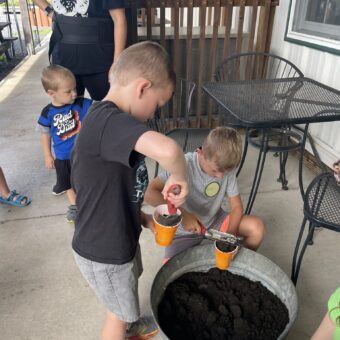Children digging up soil.