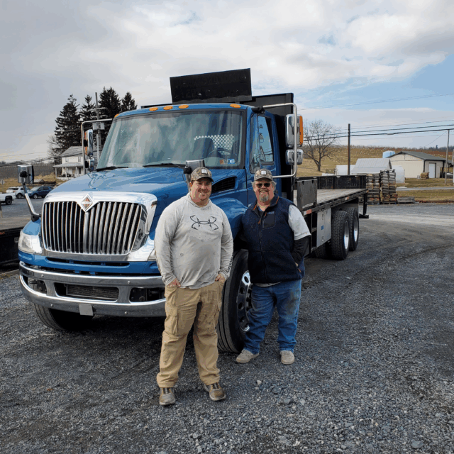 Wayne and Neil Hollabaugh in front of HBI truck.