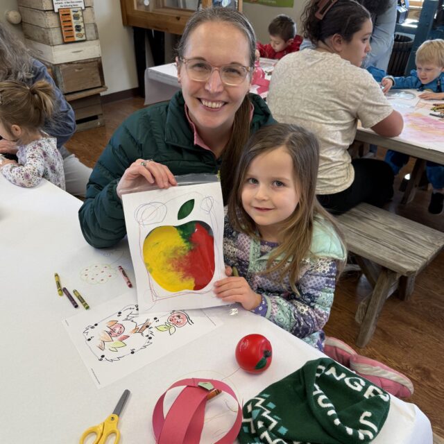 Smiling family with apple drawing