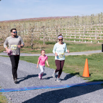 A family of three running to the finish